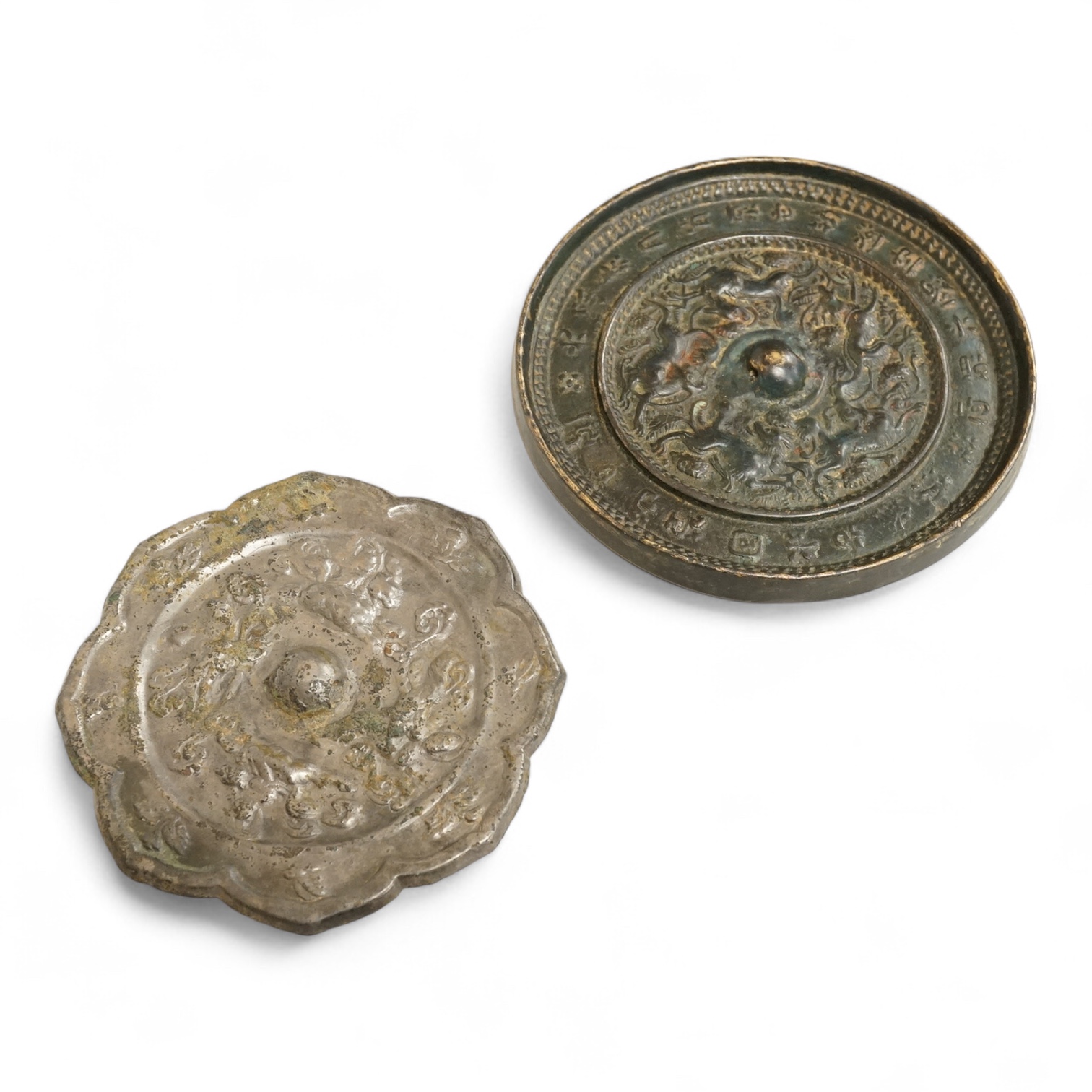 Two Chinese metal hand-mirrors, largest 13cm